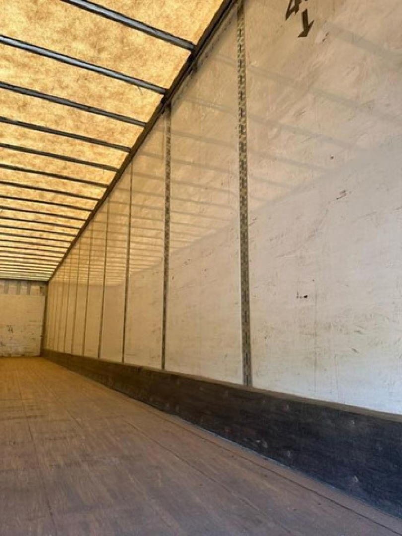 Trailer interior showing long side walls and wooden floor of a Wabash van trailer.