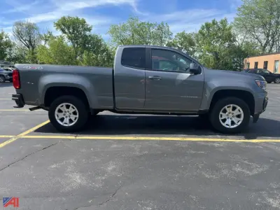 Side view of a gray 2022 Chevrolet Colorado extended cab pickup truck in a parking lot.
