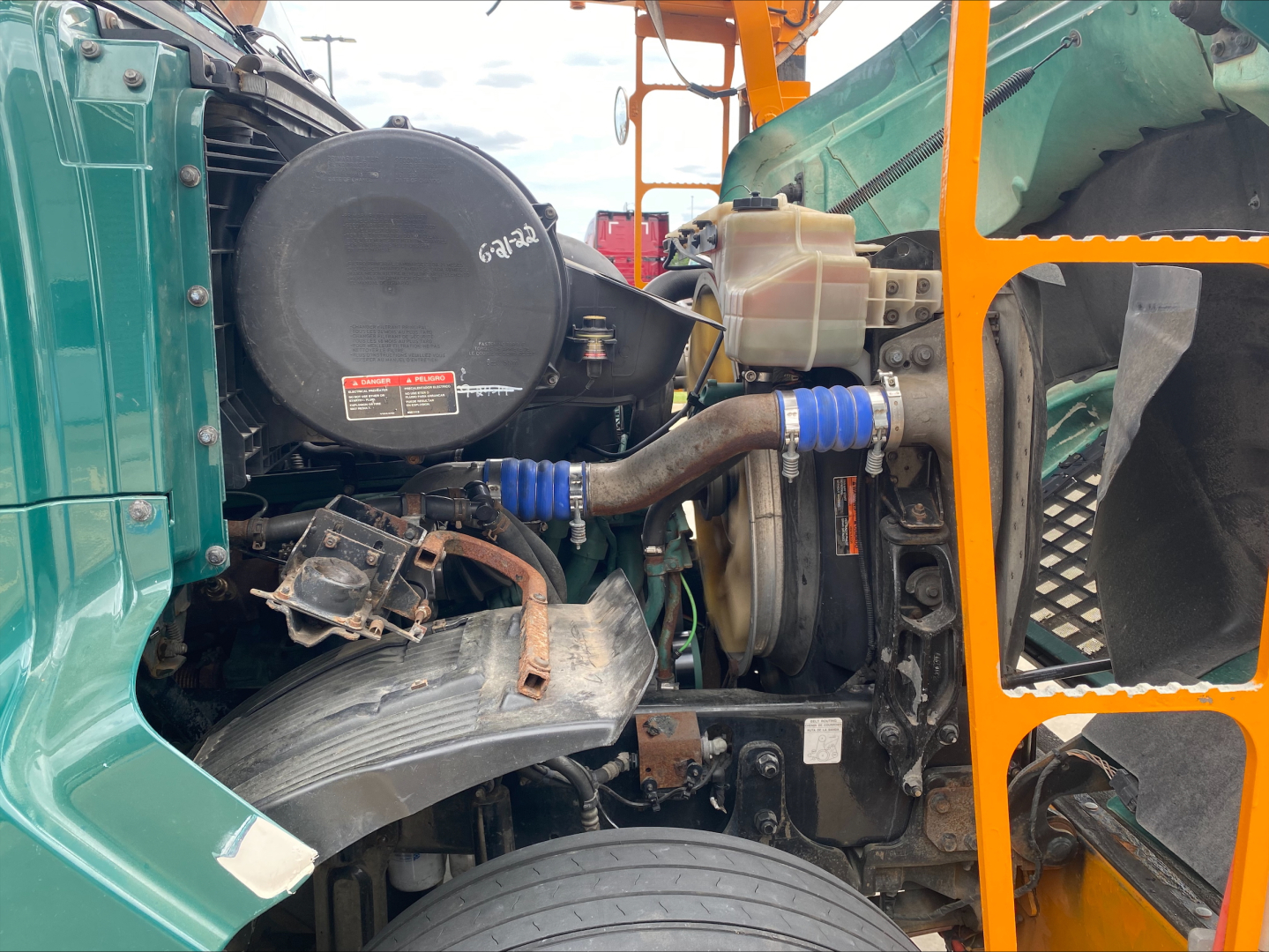 Volvo VAH engine bay showing turbocharger, hoses, coolant reservoir, and surrounding components.
