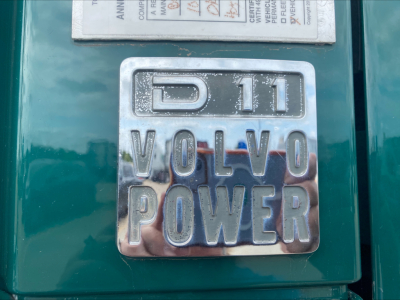 Vehicle badge close-up showing D11 Volvo Power on a green Volvo VAH truck engine bay area