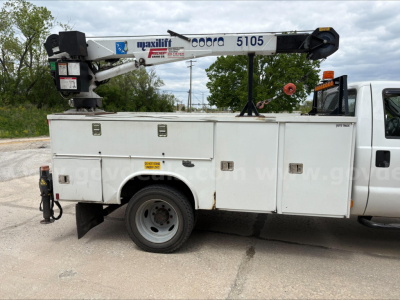 Service/Utility truck with a crane on the bed showing Maxilift Cobra 5105 and utility compartments.