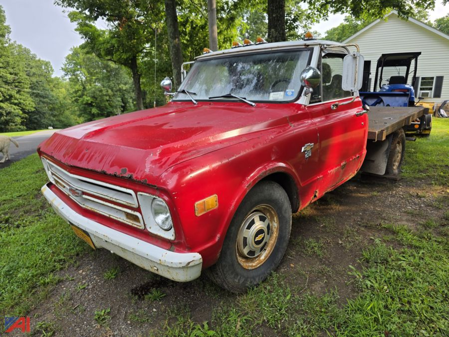 1968 Chevrolet C30 pickup truck with red body and flatbed, view of front-left side.