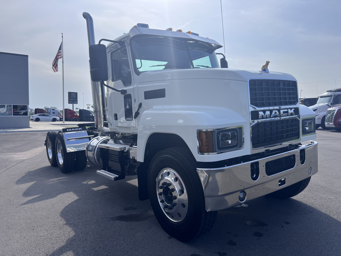 Mack PI64T truck in white facing left with front grille and chrome bumper; visible wheels and exhaust stack.