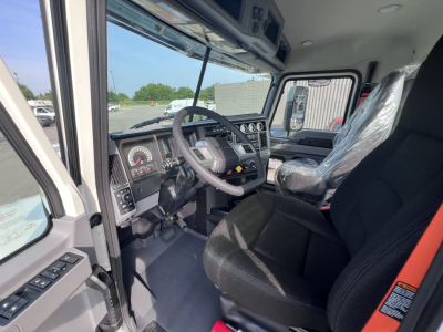 Cab interior of 2026 Mack PI64T showing steering wheel, dashboard gauges, and driver seat.