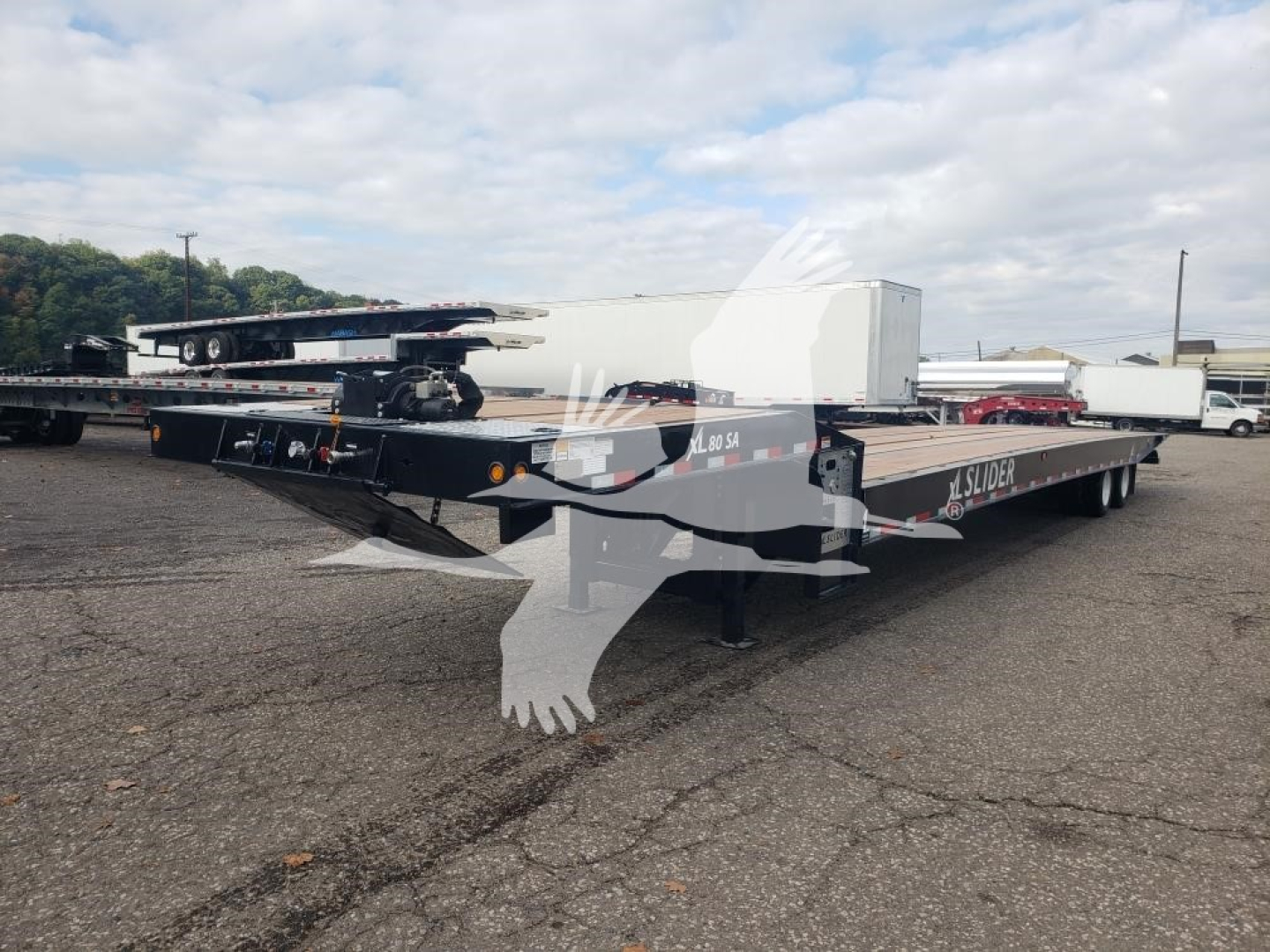 XL Specialized XL80SA traveling axle trailer showing flatbed with multiple axles and equipment, side decals reading XL80SA and SL024323.