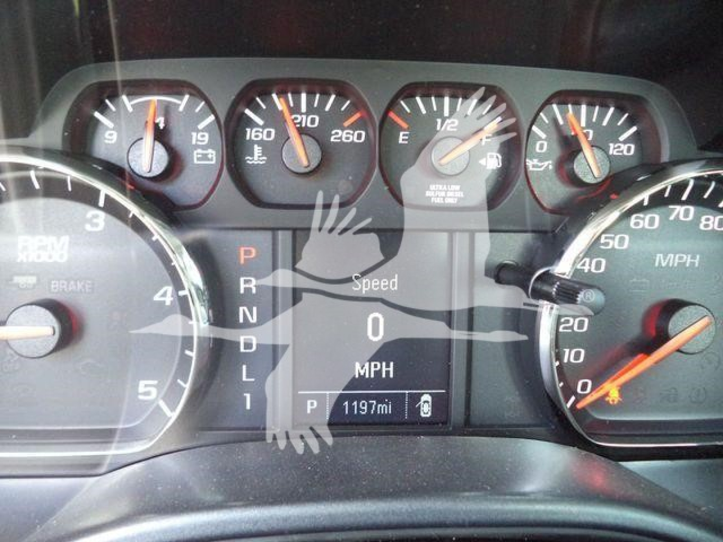 Dashboard of a 2023 International CV showing instrument cluster, gear selector PRNDL, and digital speed readout at 0 MPH with estimated 1197 miles on odometer.