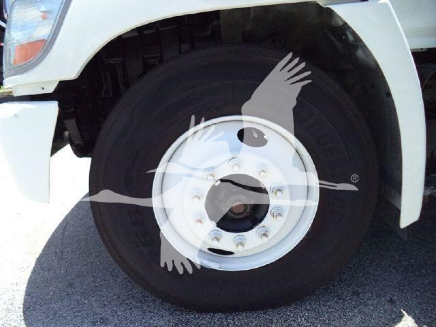Front wheel of a refrigerated 2019 Hino 268A truck showing front tire and wheel with white fender