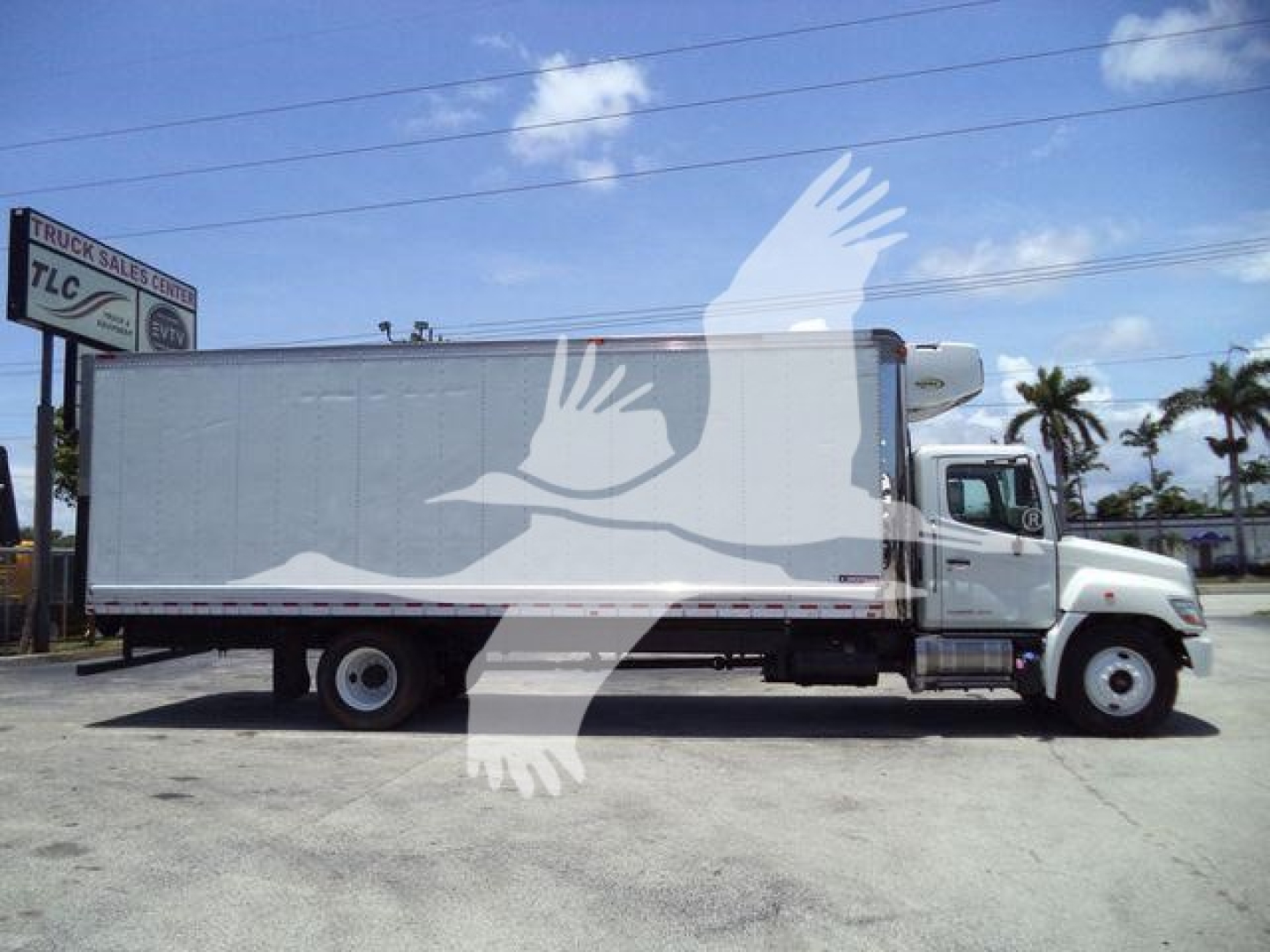 Hino 268A refrigerated truck side view with box body and cab, stock number 26198RFM visible in listing.