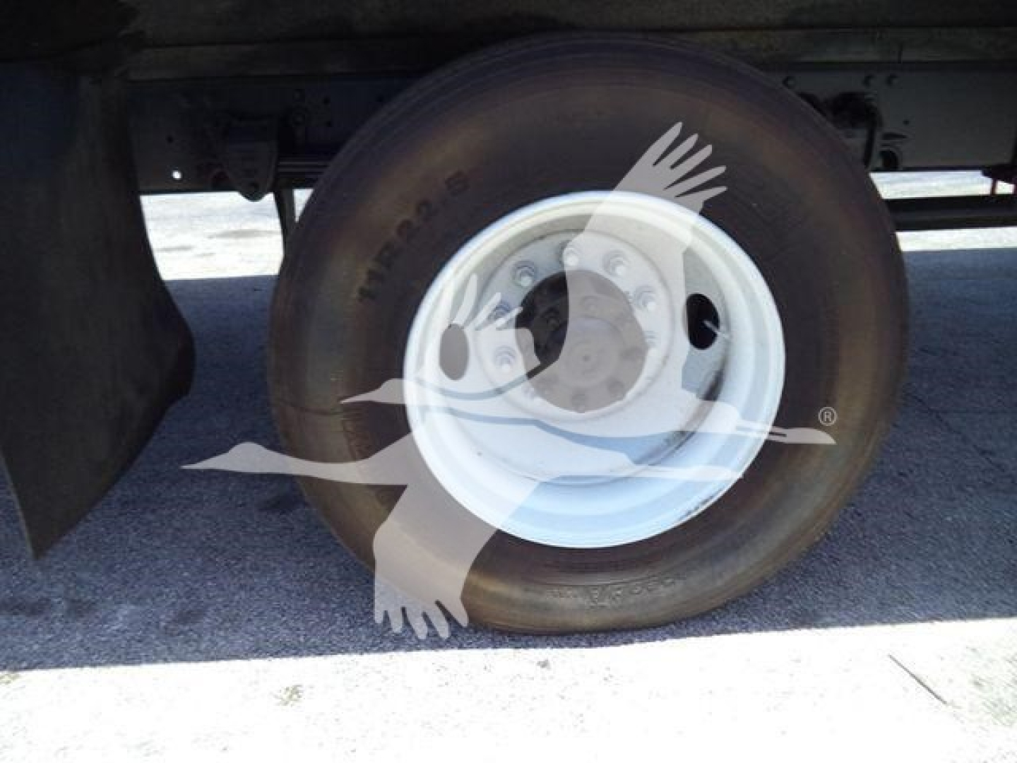Truck wheel and tire on a refrigerated Hino 268A, showing a white steel rim and tire sidewall details