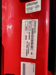 Kenworth T680 engine bay showing vehicle label with model T680, 17729 lbs GVWR, VIN 1XKYD49X9PJ230093 on a red truck door.