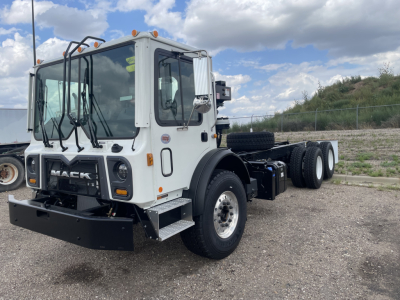 Mack TE64 truck cab and chassis in white with black bumper; front grille shows MACK branding; side mirrors; large windshield; dual rear axles; no visible cargo body attached.