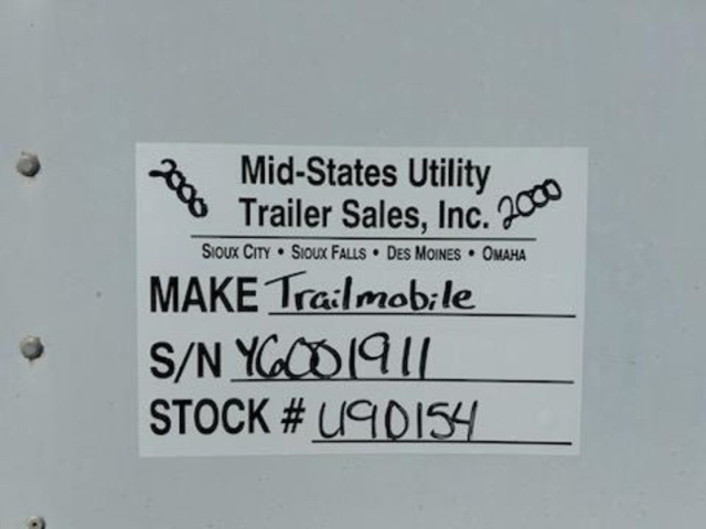 Label on trailer showing Mid-States Utility Trailer Sales, Inc. with handwritten Make Trailmobile, S/N YC001911, STOCK # U90154