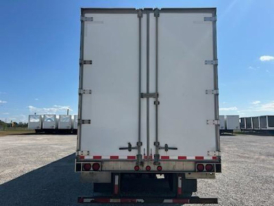 Rear view of a white trailer van with double doors and rear lights.