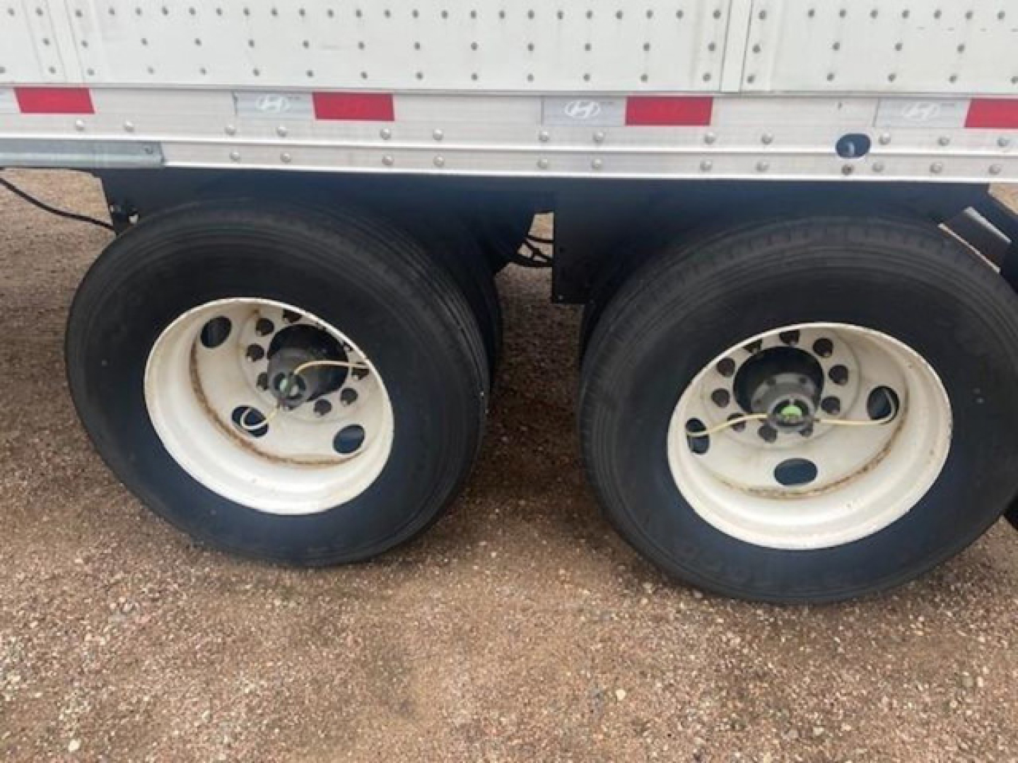 Hyundai van trailer wheel duo showing dual rear axles with white rims and black tires.