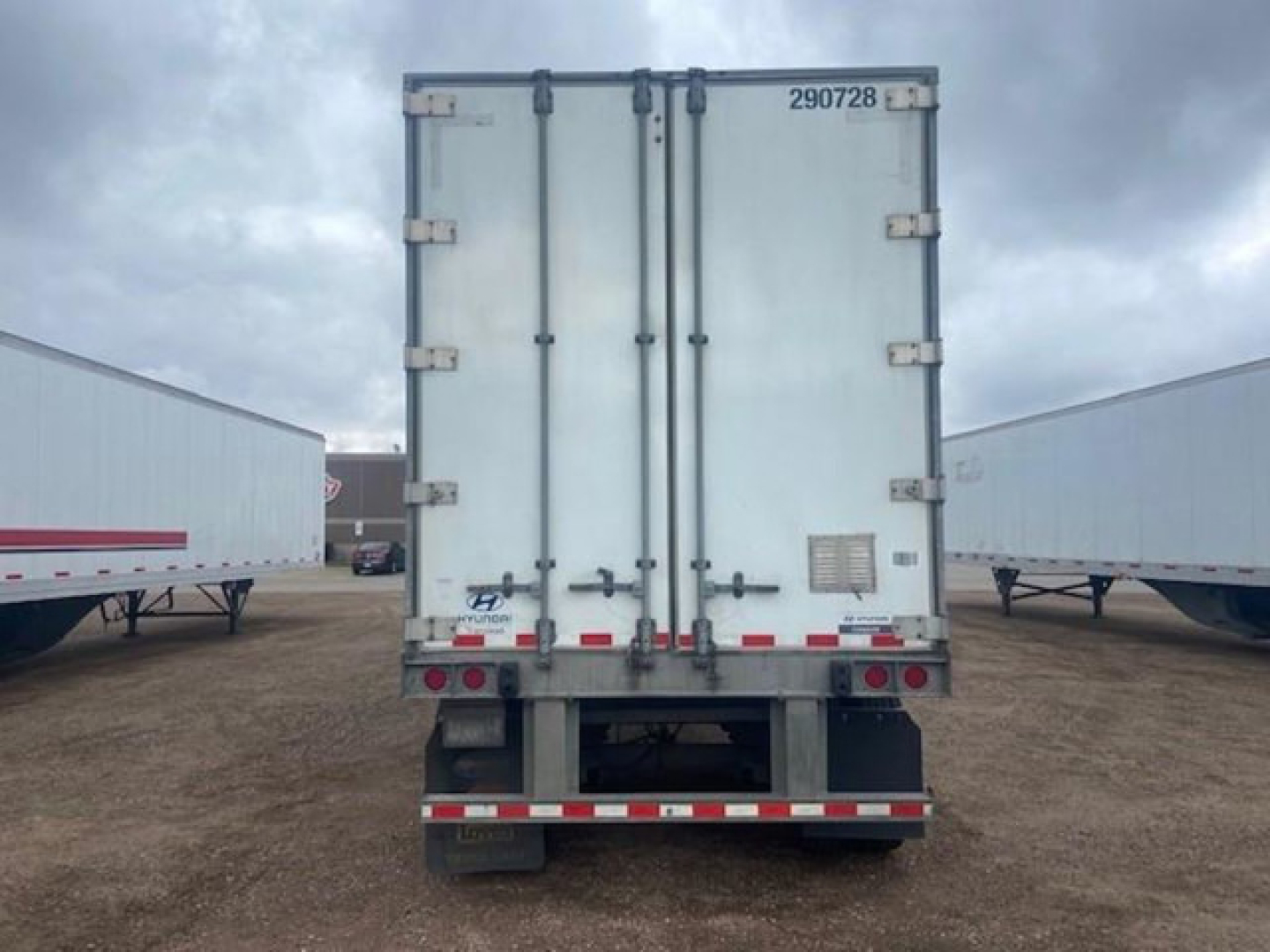 Hyundai van trailer rear view showing double doors with latches and rear bumper with reflective tape.