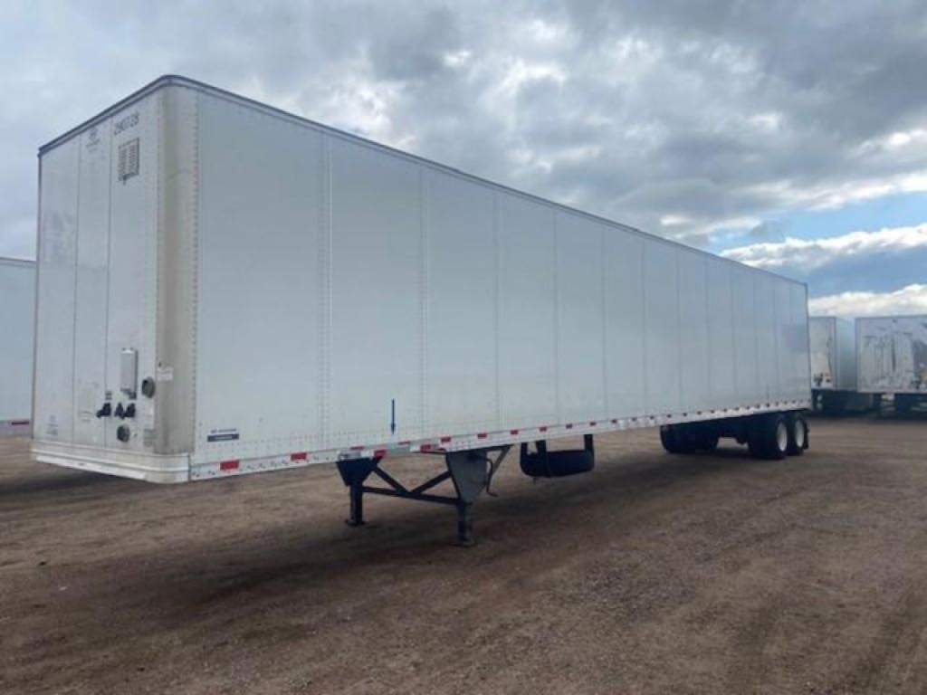 Trailer side view showing white 53' dry van trailer with front doors and landing gear.