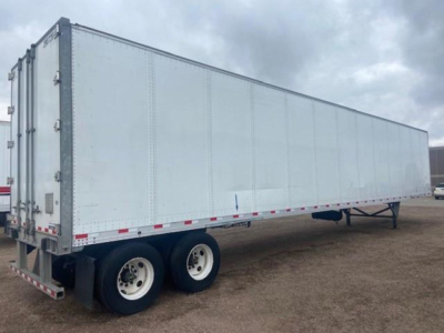 Towable white cargo trailer with dual rear wheels, side view; no legible text visible on surfaces.