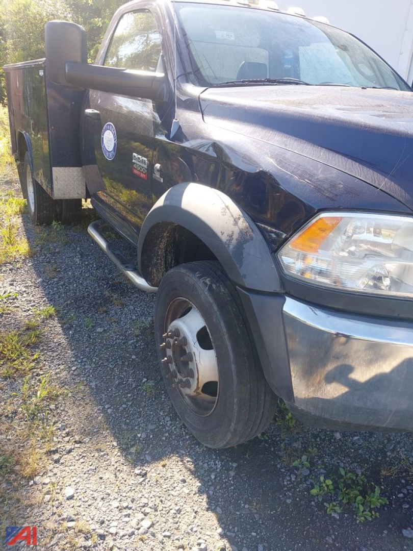 Dodge Ram 4500 chassis cab side view showing front wheel and side step, OEM badges visible.