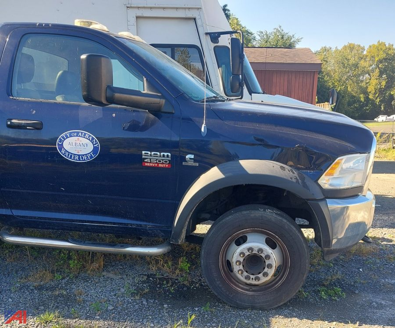 Dodge Ram 4500 chassis cab side view showing front wheel, door with RAM 4500 badge, and Albany Water Dept emblem on door.