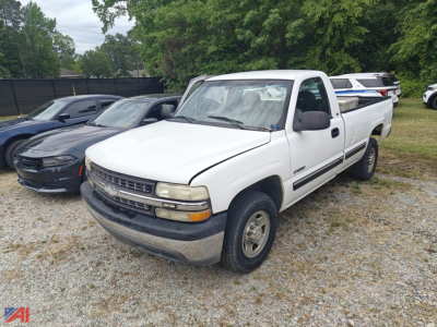 Vehicle: 2000 Chevrolet Silverado 2500 pickup truck in white, front-left view, with extended cab, two-wheel drive, in a gravel lot.