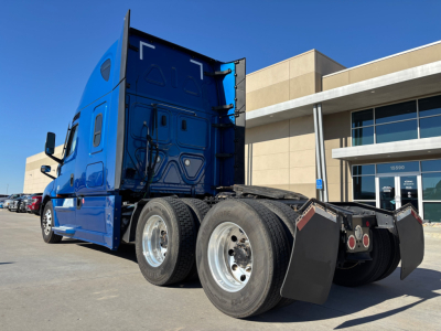  Freightliner PT126064ST conventional sleeper tractor rear view showing dual rear axles, mud flaps, and blue exterior.