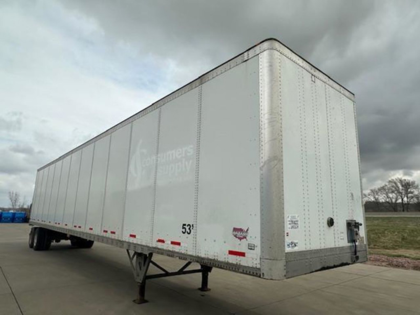 Trailer side view of a 2016 Wabash cargo trailer in white with a 53' length, curbside angle showing wheels and rear doors.