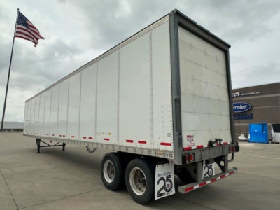 Truck trailer showing 2016 Wabash van with white riveted aluminum sides, dual rear axles, red/white reflective tape, and bumper with '25' placards.