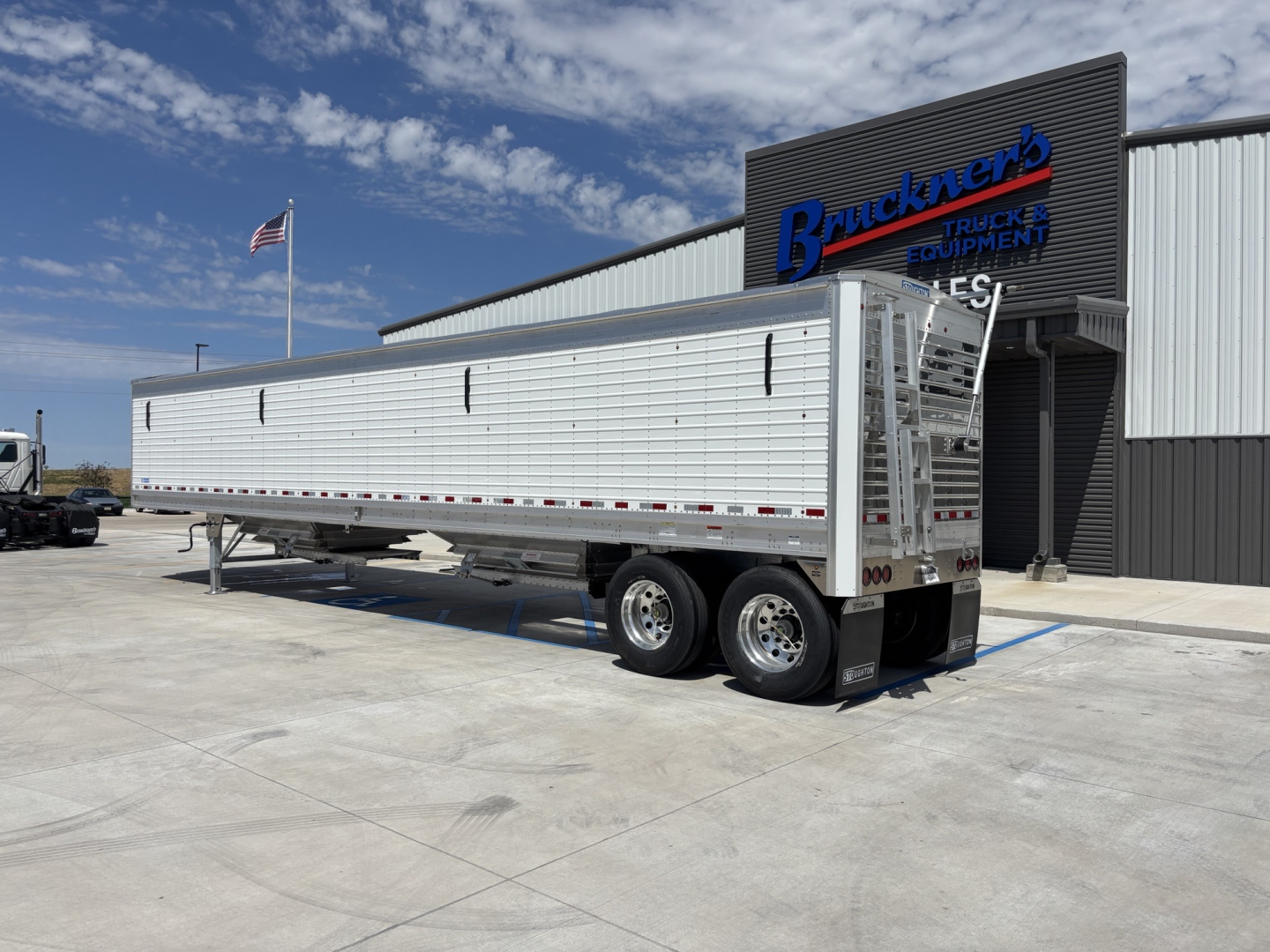 Trailer side view of a 2026 Stoughton 43' aluminum grain hopper with 80-inch sides, dual rear axles, and ladder at the front; stock number 73345 and VIN 1DW1A4300TSC21608.