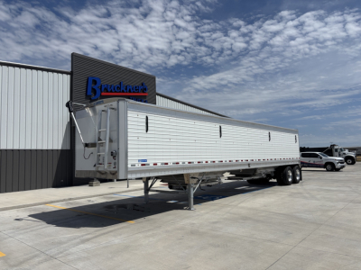 Stoughton 43' aluminum grain hopper trailer with 80 inch sides, aluminum sides with ladder and tandem axle, parked at dealership.