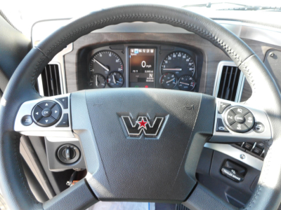 Steering wheel and dashboard view of a 2026 Western Star 49X cabin showing steering wheel controls and instrument cluster.
