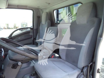 Isuzu NRR truck cab interior showing two front seats, steering wheel, and dashboard.