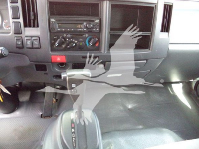 Isuzu NRR cab interior showing center console and gear shifter with dashboard controls.
