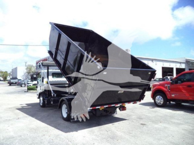 Isuzu NRR dump truck in raised bed position showing rear and side view with black bed and white cab.