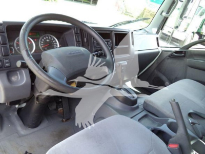 Isuzu NRR truck interior showing steering wheel, dashboard, and front seats.