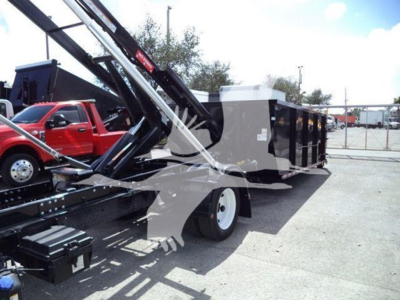 Isuzu NRR roll-off truck body with crane arm and dump container visible in side view.