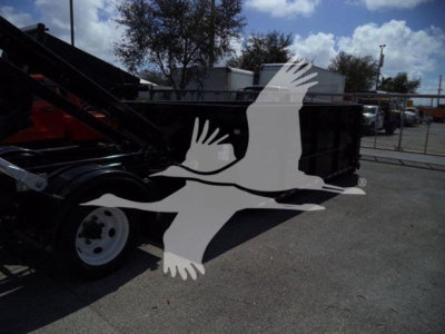 Isuzu NRR rolloff truck chassis and hydraulic arm visible with light overlay of flying birds logo.