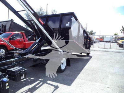 Truck scene showing a Isuzu NRR roll-off truck with hydraulic lifting arms and a dumping container in a yard.