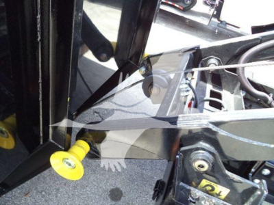 Isuzu NRR truck with lift equipment; visible labels and mechanical fittings; yellow-handled pin in foreground; metal frame and hydraulic components.