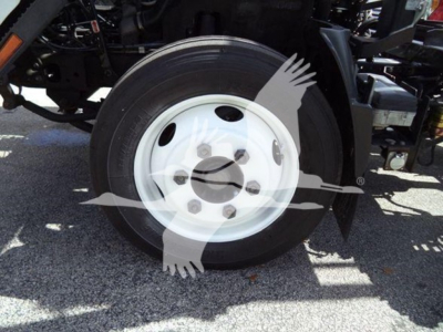 Isuzu NRR wheel and front suspension area showing white steel wheel and tire on a rolloff truck.