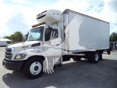 Truck refrigeration body with a front cab and a mounted overhead refrigeration unit, 2015 Hino 268A, used condition.