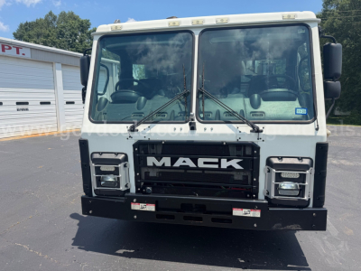 Front view of a white 2020 Mack LR truck showing grille with MAEK logo, large windshield, two wipers, and front bumper with fog lights.