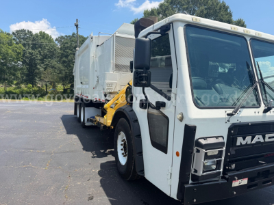 Mack LR truck with front cab and side view showing garbage body and front grille