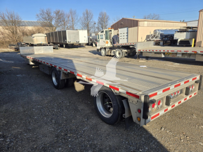 2019 Reitnouer dropdeck trailer with dual rear axles, aluminum deck, and red/white safety markings. Side and rear showing taillights and bumper.