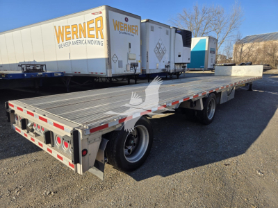 2019 Reitnouer Dropmiser trailer showing flatbed deck and wheels with Werner trucks in background.