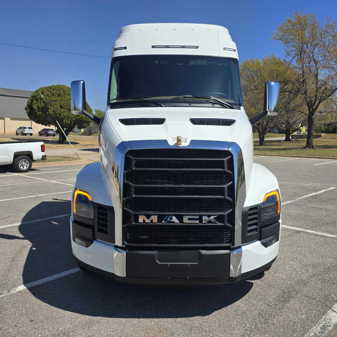 Mack PR64T76M truck front view showing grille, headlights, and hood emblem.