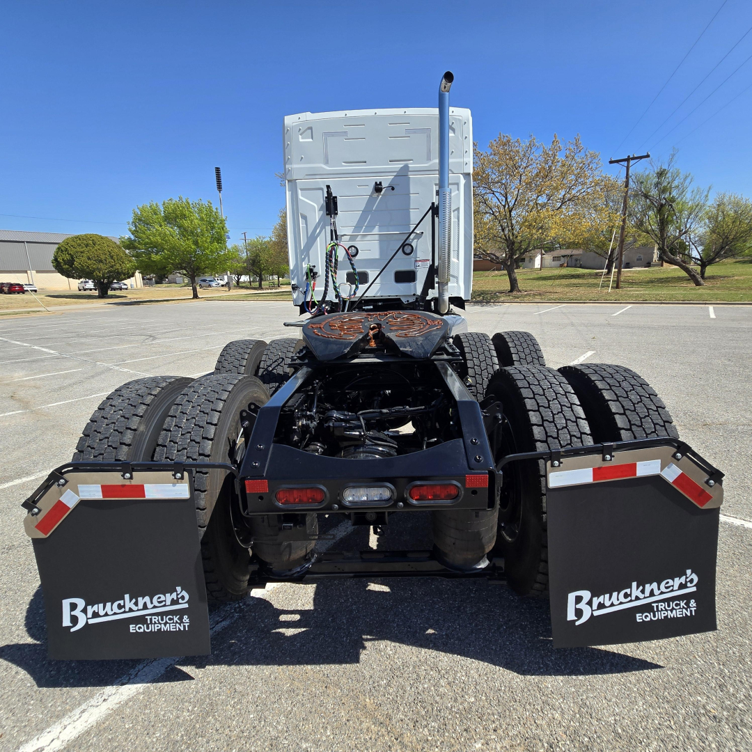 Tractor-trailer truck chassis showing rear view with six wheels, mud flaps labeled Bruckner's Truck & Equipment, and fifth wheel mount.