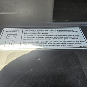 Mack label showing 12 and 24 Volt battery systems information and icons on the dash area.