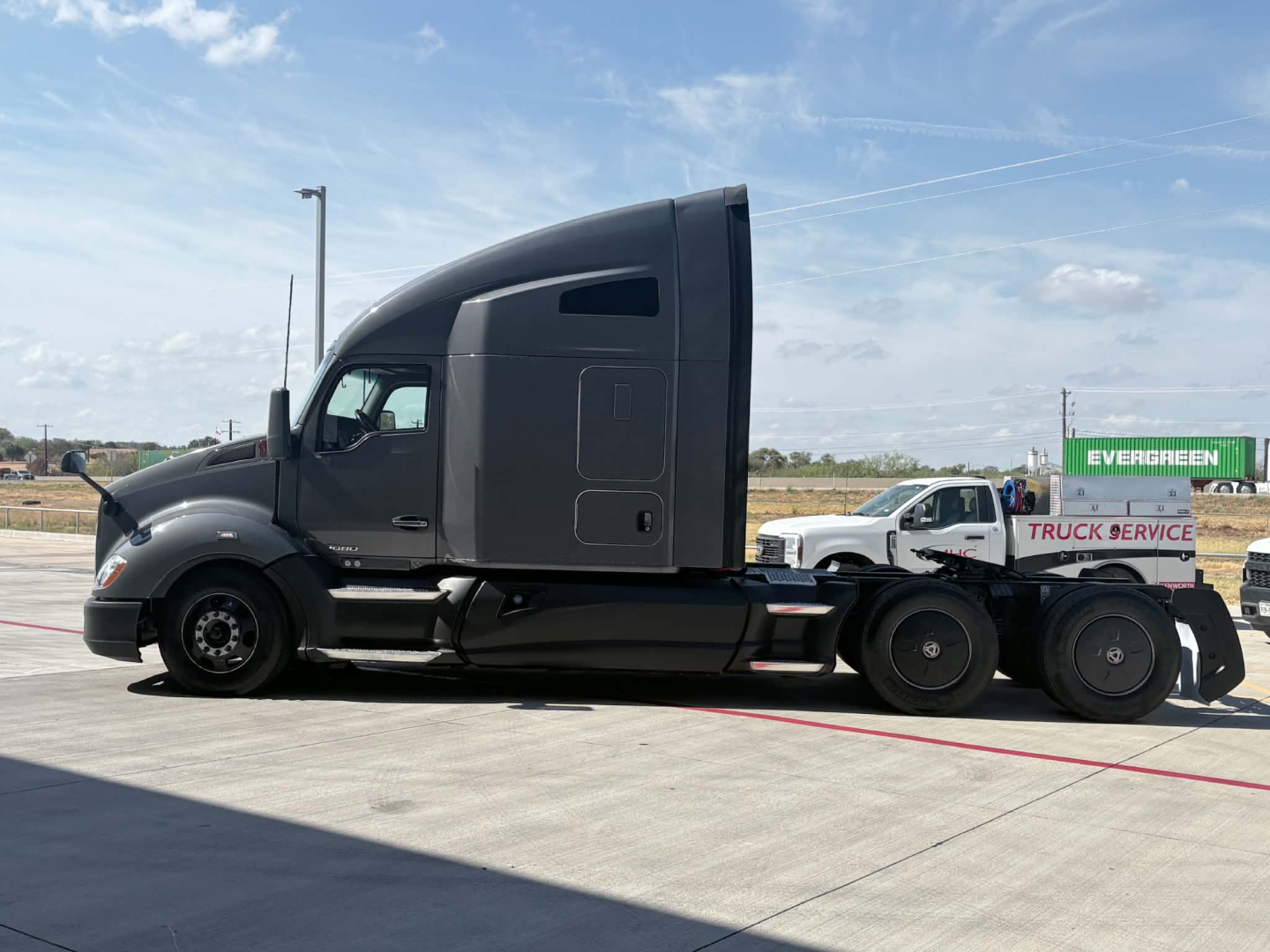 Kenworth T680 tractor in profile view showing sleeper cab and rear axle configuration.