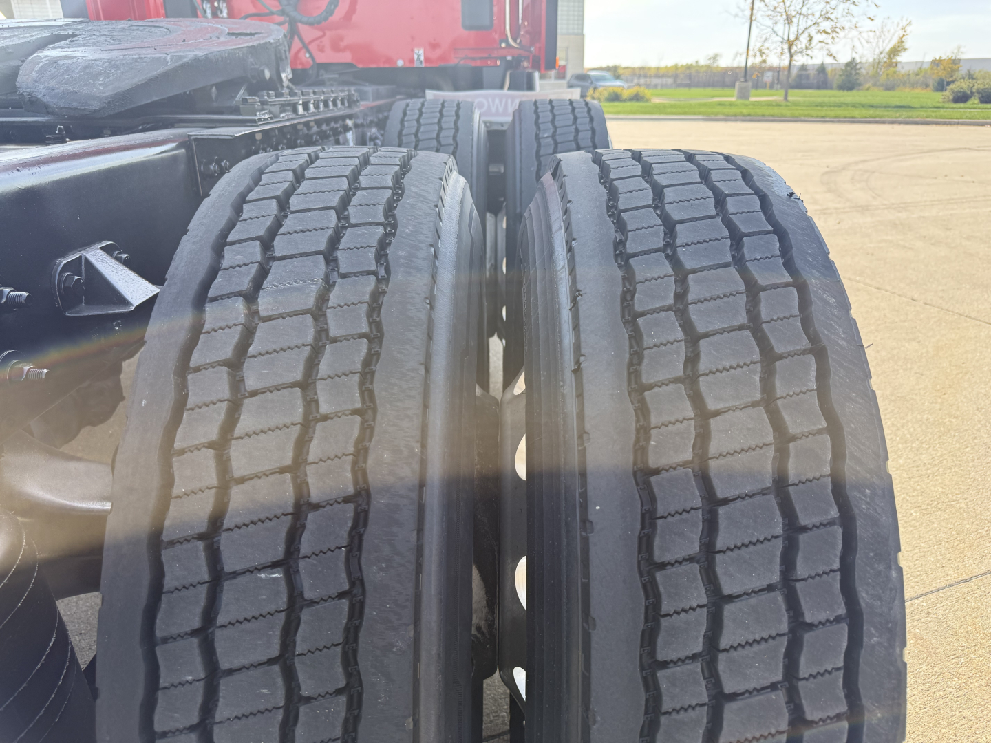 Dual rear wheels of a Kenworth T680 tractor showing treaded tires and axle area.
