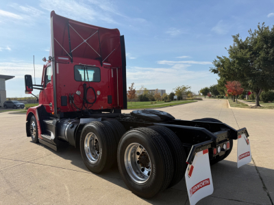 Kenworth T680 tractor back view showing dual rear axles and mud flaps with Kenworth branding.